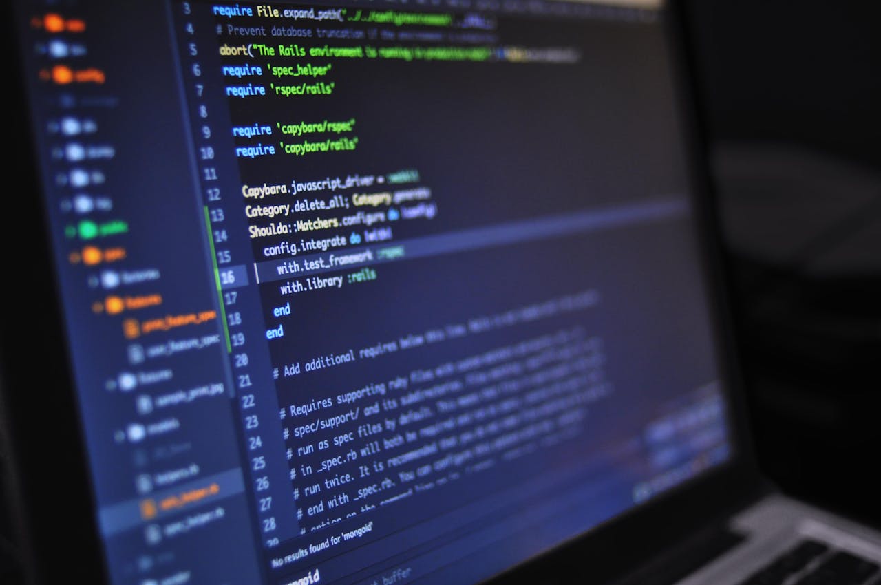 Home Close-up of a computer screen displaying programming code in a dark environment.
